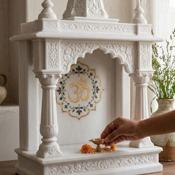 Handcrafted white marble mandir with elegant carving for home pooja room.